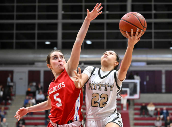 St. Ignatius' Stephanie Frias with strong defense on left-hand layup attempt by Sofia Teresi (22).